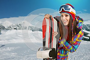 Female snowboarder on top of the mountain