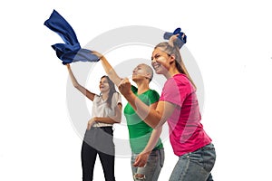 Female soccer fans cheering for favourite sport team with bright emotions isolated on white studio background
