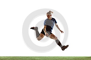 Female soccer, football player kicking ball, training in action and motion with bright emotions isolated on white