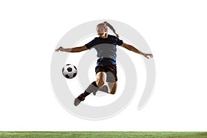 Female soccer, football player kicking ball, training in action and motion with bright emotions isolated on white