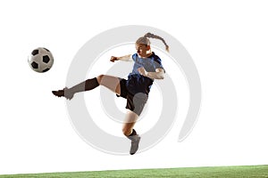 Female soccer, football player kicking ball, training in action and motion with bright emotions isolated on white