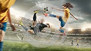 Female soccer or football players kicking ball at the stadium
