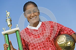 Female Soccer Player Holding Trophy
