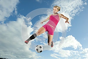 Female Soccer Player Kicking a Ball