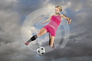 Female Soccer Player Kicking a Ball