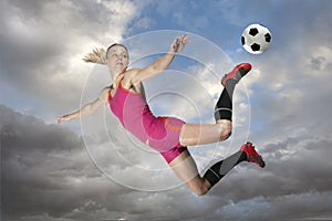 Female Soccer Player Kicking a Ball