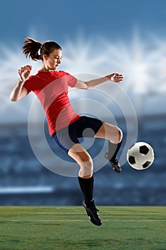 Female Soccer Player Kicking Ball