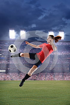 Female Soccer Player Kicking Ball