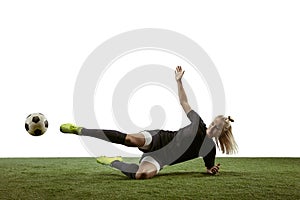 Female soccer player kicking ball at the stadium