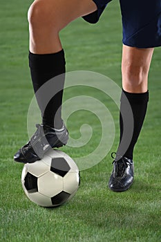 Female Soccer Player Stepping on Ball