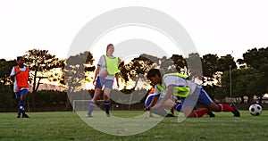 Female soccer player tackling down another player on soccer field. 4k