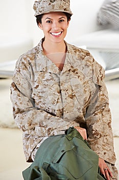 Female Soldier With Kit Bag Home For Leave