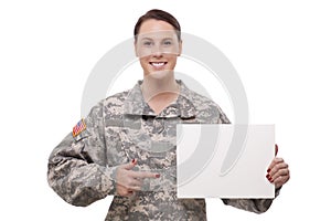 Female soldier pointing at a blank placard