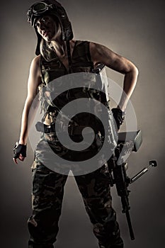 Female soldier in uniform with machine gun