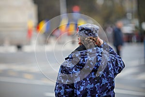 Female soldier woman in the military takes part at the Romanian National Day military parade