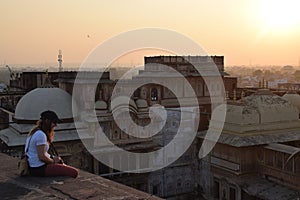 Female solo traveler enjoys the sunset view in India