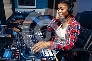 Female sound operator in audio recording studio