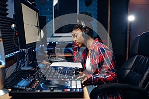 Female sound operator in audio recording studio