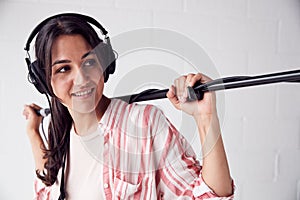 Female Sound Recordist Holding Microphone On Video Film Production In White Studio