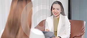 Female Southeast Asian psychologist doctor consults in a psychotherapy session with a female