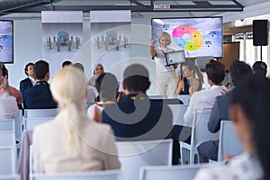 Female speaker announcing award in a business seminar