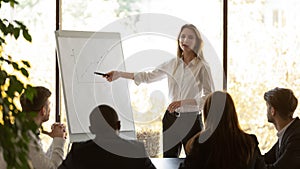 Female speaker give flip chart presentation at conference training meeting