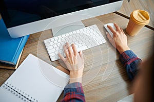 Female IT specialist hands on keyboard in office