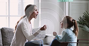 Female speech therapist teaching preschool kid girl learning articulation