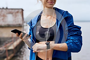 Female sportsman synchronizing gadgets outdoor