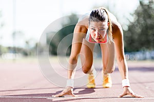 Female sprinter getting ready for the run