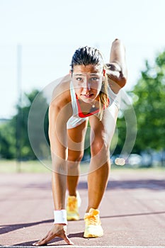 Female sprinter getting ready for the run