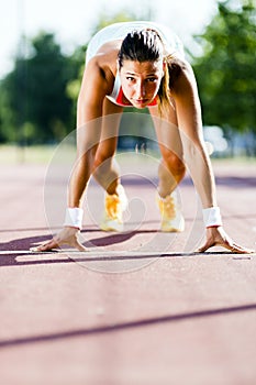 Female sprinter getting ready for the run