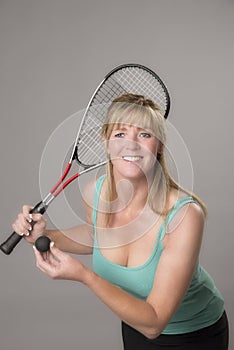 Female squash player with raquet and ball