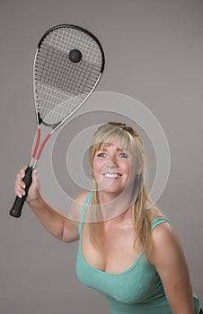 Female squash player with raquet and ball photo