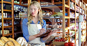 Female staff maintaining a stock record