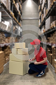 Female staff and parcel boxes checking stock and Blurred the background of the warehouse