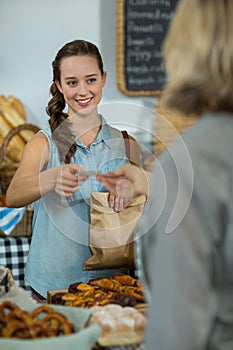 Female staff receiving a payment from customer at counter