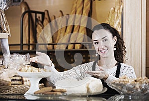 Female staff selling fresh pastry and baguettes