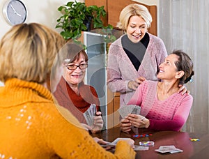 Female staking money during bridge