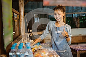 female stall keeper shows thumbs up while setting the table