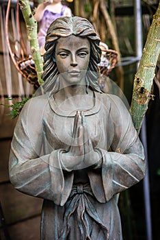 Female statue praying hands