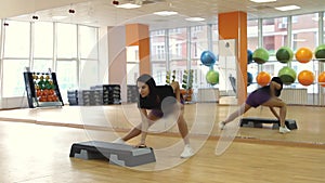 Female on the step board during exercise.