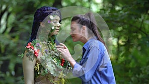 Female stroking flowers admiring nature beauty, earth personification connection