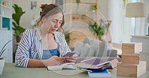 Female Student Browsing Smartphone While Learning at Desk