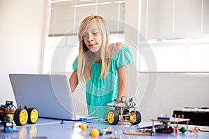 Female Student Building And Programing Robot Vehicle In After School Computer Coding Class