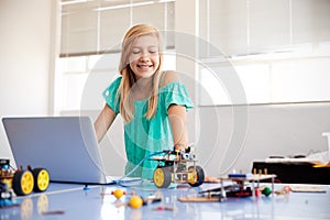 Female Student Building And Programing Robot Vehicle In After School Computer Coding Class