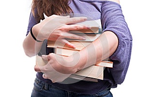 Female student carrying a pile of books