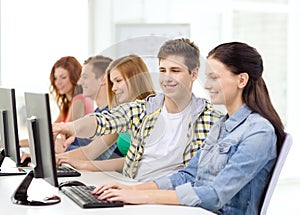 Female student with classmates in computer class