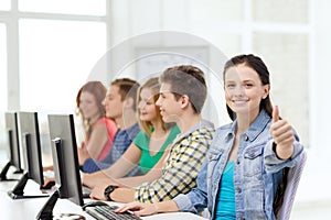 Female student with classmates in computer class