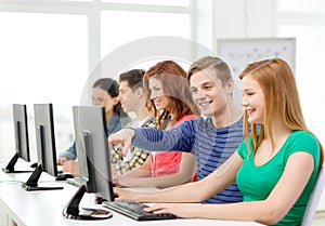 Female student with classmates in computer class